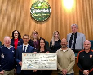 TruStone Financial employees presented a check for $10,000 to the City of Greenfield to fund the warming area of its public ice skating rink at Konkel Park.