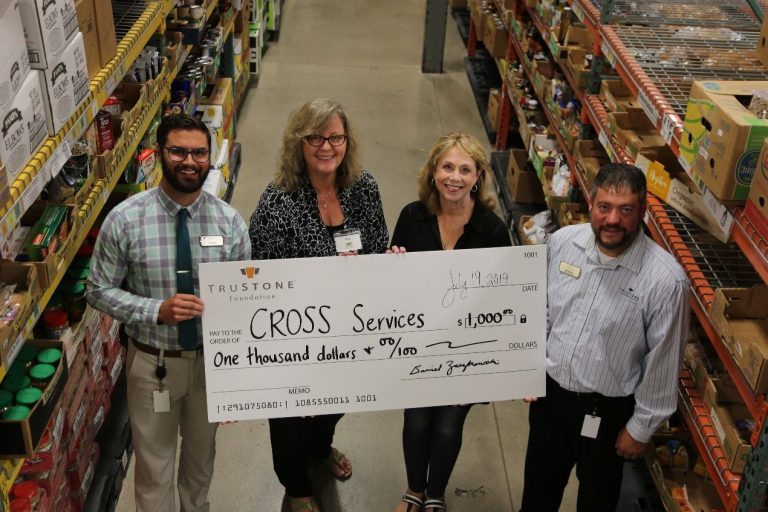 Staff from the Rogers branch of TruStone Financial presented a check for $1,000 to CROSS Services staff at the organization’s food and clothing shelf in Rogers.