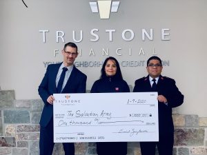 Tim Osten, Branch Manager at the Greenfield, WI location of TruStone Financial, presented a check for $1,000 to Salvation Army Corps Officer Alex Yanez and his wife, Carolina.